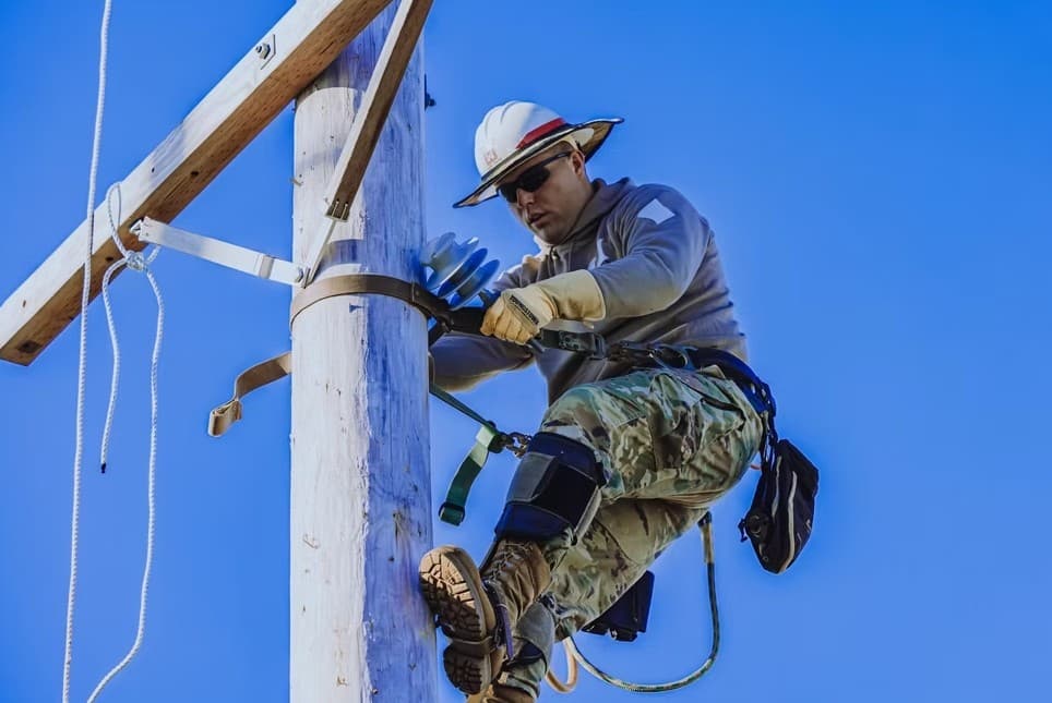 Lineman at work on power lines